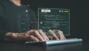 Person typing on a laptop with holographic code overlay, illustrating coding and software development.